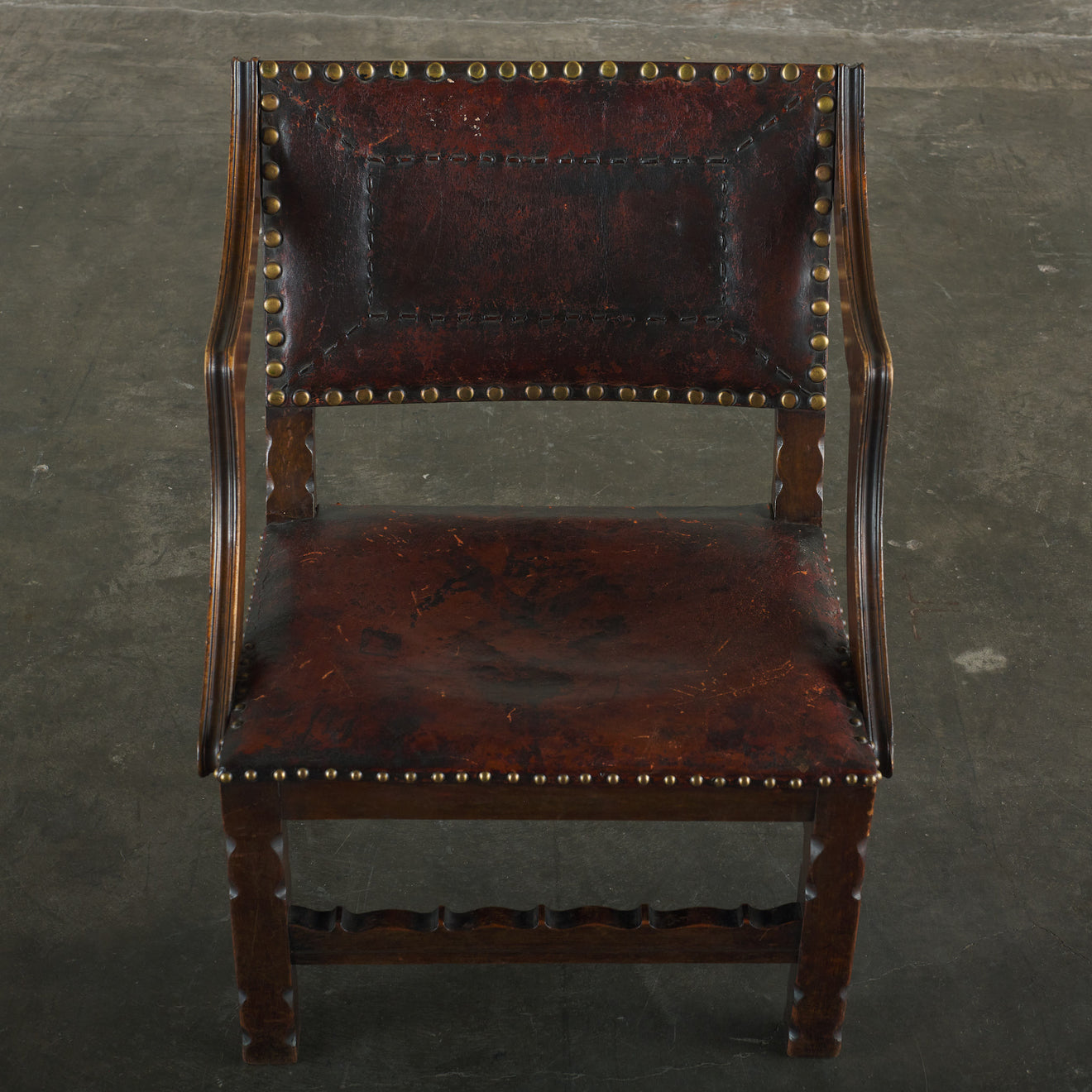 SPANISH COLONIAL LEATHER STUDDED LOW ARM CHAIR
